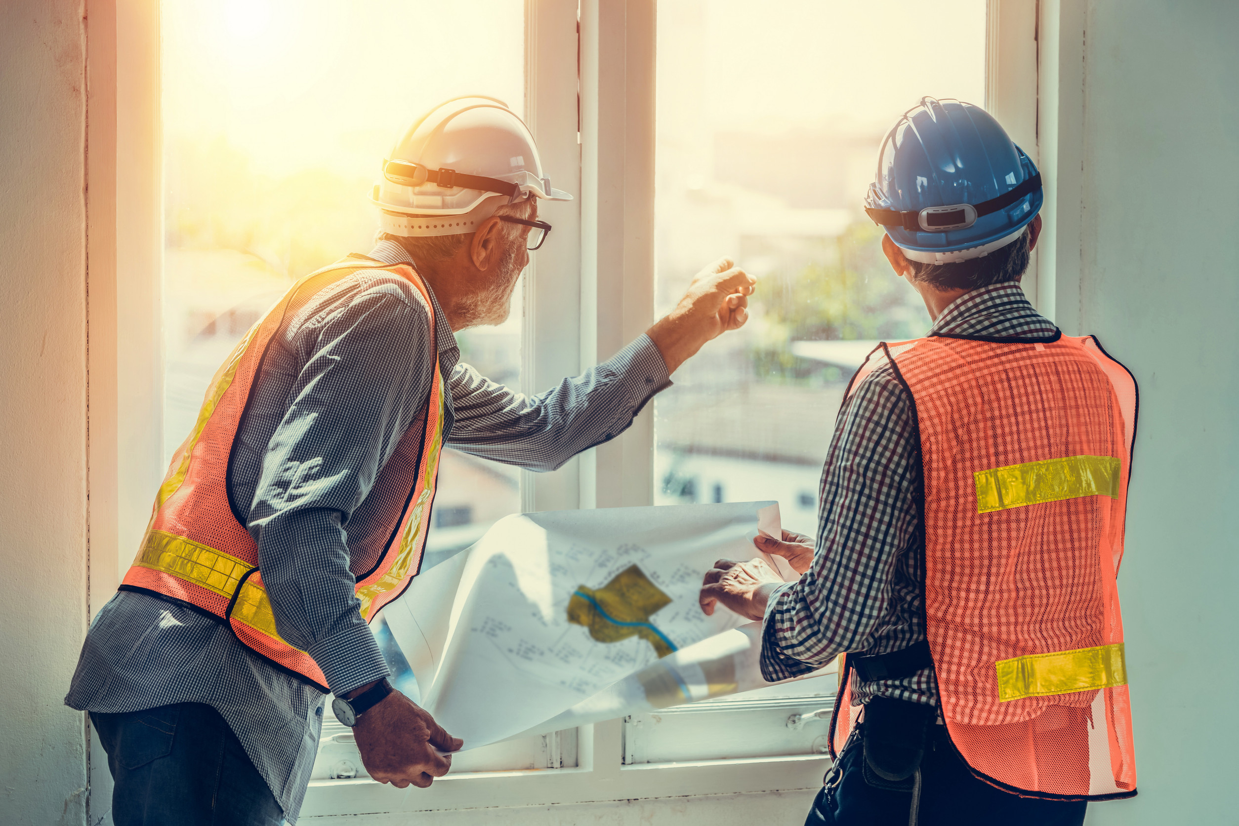 Senior engineer and architect working with drawing